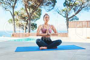 Theres no better way to deal with challenges. a young female athlete practising yoga at home.