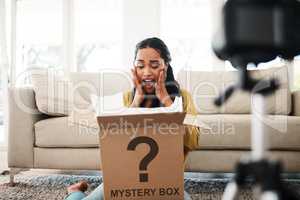 This is such a nice surprise. an attractive young businesswoman sitting in her living room and vlogging her reaction to a mystery box.
