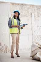 Everythings on schedule. Full length shot of an attractive young female construction worker working on site.