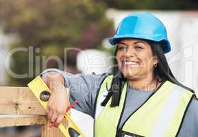 Im almost done here. Cropped portrait of an attractive young female construction worker working on site.