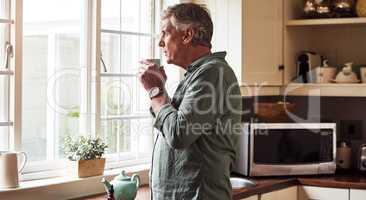 Now to just relax. a relaxed senior man preparing a cup of tea with CBD oil inside of it at home during the day.