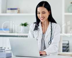 The right technology can make a quicker diagnosis. a young doctor using a laptop at her desk.