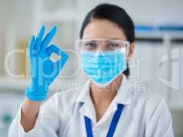 Ive made the breakthrough weve been waiting for. Portrait of a confident young woman making an okay gesture in a laboratory.