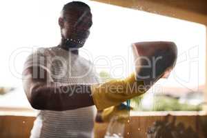 Keep your windows clean. a man washing his windows at home.