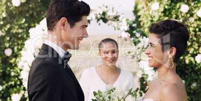 Loving you makes life worth living. an affectionate young couple smiling at each other while saying their vows on their wedding day.