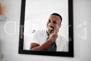 Now I feel fresh and ready to take on the day. a man looking into the mirror while drying his face with a towel.