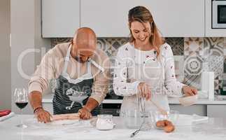Lots of fun is on the menu. a happy mature couple baking together at home.