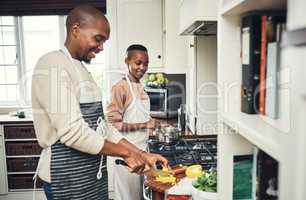 A meal prepared with love is always better. an affectionate young couple preparing dinner in their kitchen.