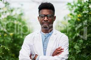 Saving our wonderful earth will always be a serious issue. Portrait of a handsome young botanist posing with his arms folded outdoors in nature.