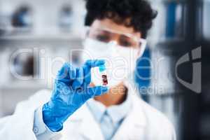 Working hard to create a cure thatll save many lives. Closeup shot of a young scientist working with samples in a lab.