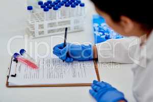 Noting down her findings with accuracy. Closeup shot of an unrecognisable scientist writing notes while working in a lab.