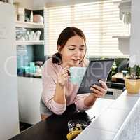 Theres some interesting stories in the news today. a young woman drinking coffee while using a digital tablet.