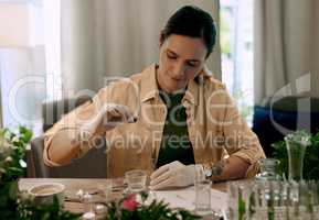 Hydroponic grown plants have higher bacteria and pest resistance. an attractive young botanist adding a liquid nutrient to a water based plant inside a test tube.