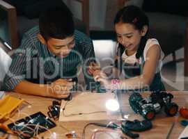 Its time to turn on the lights. two adorable young siblings making an electric circuit together at home.