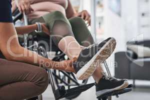 Lets take the first step towards recovery. an unrecognizable physiotherapist doing leg exercises with her wheelchair bound patient inside her office at a clinic.