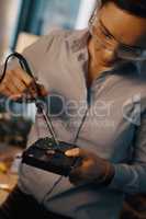 Hard drives are a lot more durable than youd think. an attractive young female computer technician repairing a hard drive in her workshop.