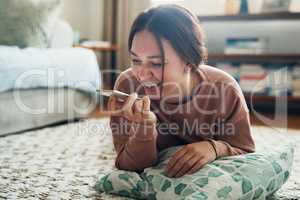 You never know who needs to hear you say hello. a young woman using a smartphone while relaxing at home.