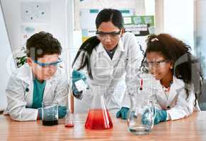 Discovering the wonders of the world with science. an adorable little boy and girl conducting a scientific experiment with their teacher at school.