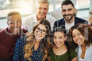 Teamwork, smiling and diverse workers standing together in a creative workplace. Portrait of group of casual businesspeople and colleagues looking happy. Team of professionals ready for collaboration