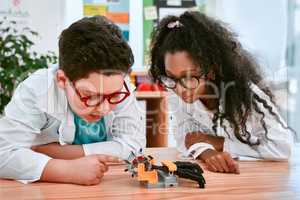 Future engineers in the making. an adorable little boy and girl building a robot in science class at school.