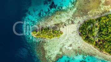 Travelling is what feeds the soul. High angle shot of the Raja Ampat Islands surrounded by a clear ocean during a vacation in Indonesia.