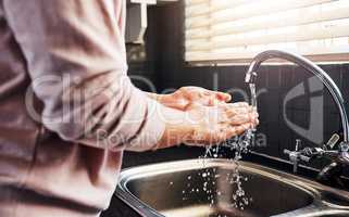 -..Keep your hands clean at all times. an unrecognizable woman washing her hand in the kitchen sink.