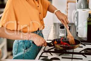 If youre going to fry, why not stir fry. a young woman preparing a healthy meal at home.