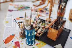 Pick up a brush and start painting. Still life shot of paintbrushes lying on the floor in a art studio.
