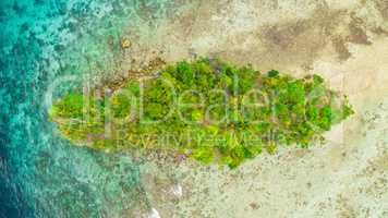 Islands are the perfect holiday destination. High angle shot of a little islet in the middle of the wonderful Raja Ampat Islands in Indonesia.