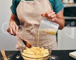 Its going to taste great at the end. an unrecognizable woman baking inside her kitchen at home.