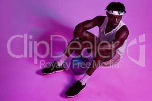 The sport is a part of who I am. Red filtered shot of a young sportsman posing with a basketball in the studio.