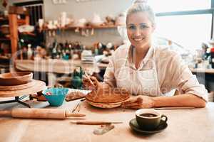 I took the leap and started creating full time. a female artisan working in her pottery workshop.