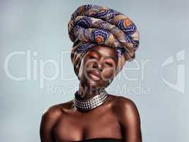 Radiance is the essence of beauty. Studio shot of a beautiful young woman wearing a traditional African head wrap against a grey background.