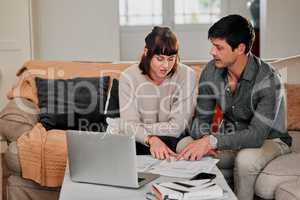 What amount are we paying. a couple sitting with their laptop and paperwork at home.