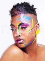 Were all living in a world of color. a gender fluid young man wearing face paint against a white background.