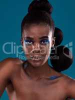 Avant garde never goes out of style. Studio portrait of a beautiful young woman posing against a turquoise background.