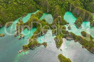 Indonesian beauty. High angle shot of a little islets and islands in the middle of Indonesia.