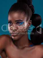 Her beauty is beyond compare. Studio shot of a beautiful young woman posing against a turquoise background.