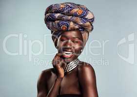 Ive got a different print for every occasion. Studio shot of a beautiful young woman wearing a traditional African head wrap against a grey background.