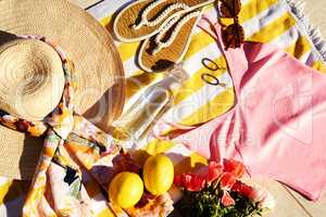 Welcoming summer with bright colours. High angle shot of neatly arranged summer wear laid out on a beach towel during the day.