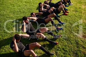 Why stop there. a diverse group of sportsmen training during a rugby practice in a sports club.