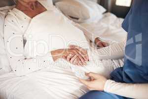 Whatever the weather well get through it together. a nurse holding hands with a senior woman.