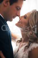 I have searched for you all my life. a happy young couple standing indoors and looking at each other lovingly after their wedding.