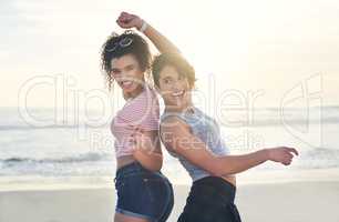 Summer has everyone feeling extra groovy. two female friends spending the day at the beach.