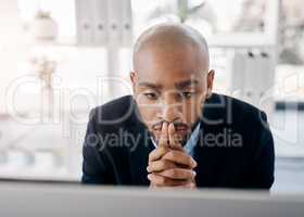 Stop doubting yourself and start to own your worth. a young businessman looking worried while sitting at his desk.