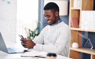 Taking action is the first step to success. a young businessman using a smartphone in a modern office.