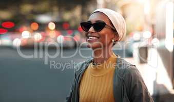 Spending time in a sunny city. an attractive young woman wearing a hijab and sunglasses while touring the city.