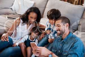 Does everyone approve of this selfie. a family of four watching something on a cellphone.