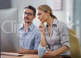 Professional businesspeople developing strategy, ideas and brainstorming in front of computer in the office space. Businessman and businesswoman analyzing data, partners discussing business plan.