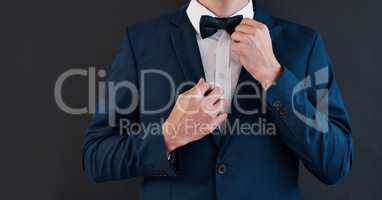 Its his day, hes gotta have the best tie. an unrecognizable bridegroom adjusting his bowtie in preparation for his wedding.